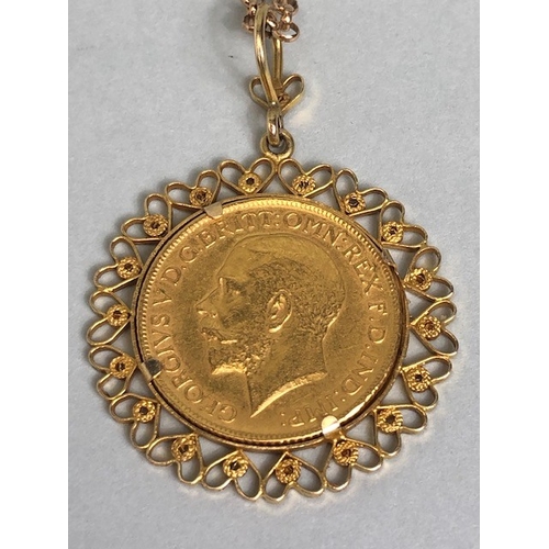 20 - Gold Sovereign dated 1911, in a fancy 9ct pendant mount of hearts, suspended from a 9ct gold belcher... 