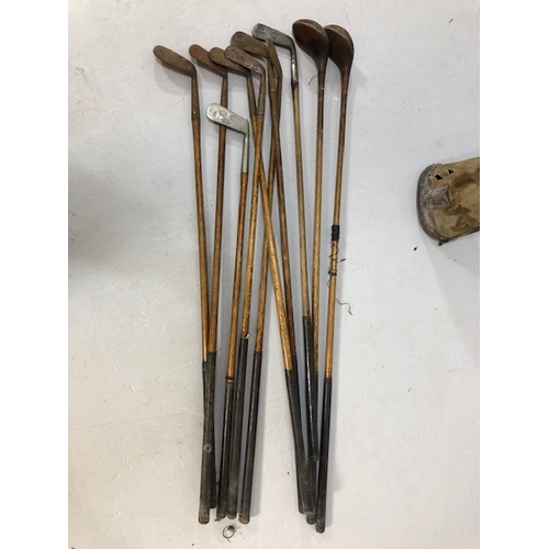 207 - Antique and vintage sporting equipment, set of golf clubs, woods, irons and putters in canvas bag