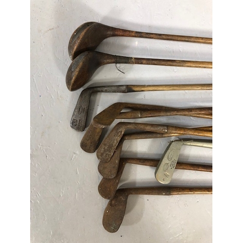 207 - Antique and vintage sporting equipment, set of golf clubs, woods, irons and putters in canvas bag