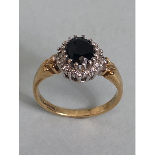 22 - 9ct Gold ring set with large dark faceted Sapphire and surrounded by Diamonds approx size 'L'