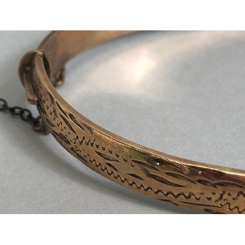 33 - Gold bangle marked 710 9ct, half plain half engraved design approximately 15.7g