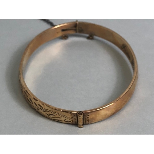 33 - Gold bangle marked 710 9ct, half plain half engraved design approximately 15.7g