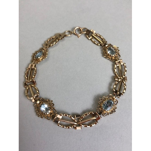 36A - 9ct Gold bracelet with four pale blue gemstones set in pierced panels approx 7cm in length and 5.7g