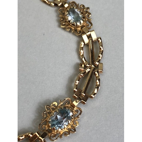 36A - 9ct Gold bracelet with four pale blue gemstones set in pierced panels approx 7cm in length and 5.7g