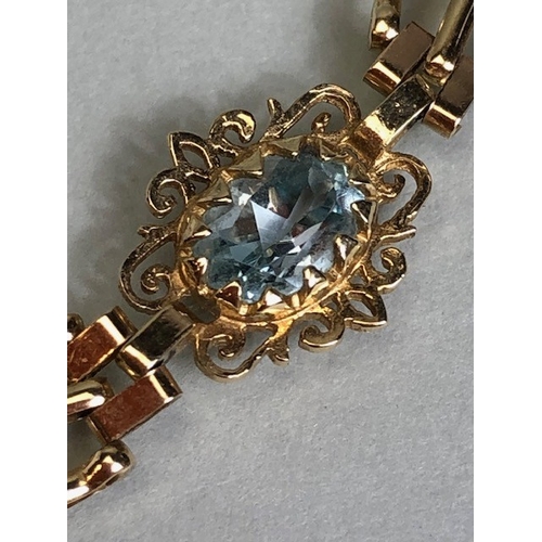 36A - 9ct Gold bracelet with four pale blue gemstones set in pierced panels approx 7cm in length and 5.7g