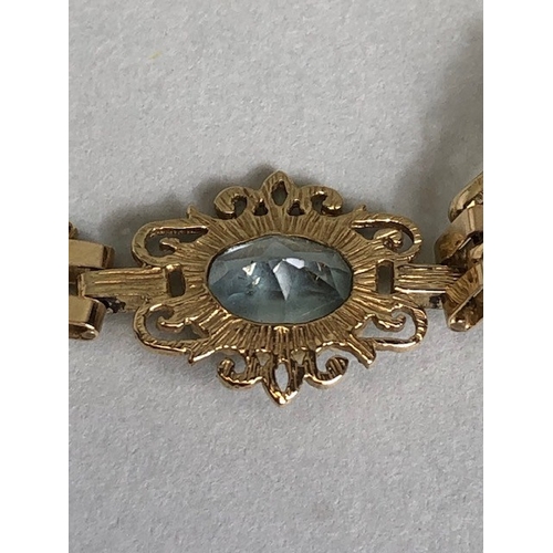 36A - 9ct Gold bracelet with four pale blue gemstones set in pierced panels approx 7cm in length and 5.7g