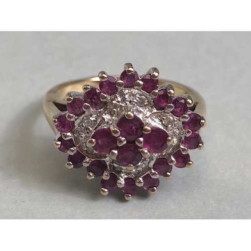 38 - 9ct gold quatrefoil cluster ring set with rubies and diamonds, in a white gold setting, approximatel... 