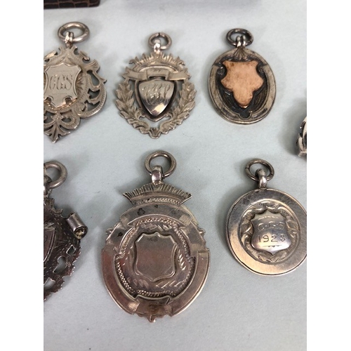 46 - Collection of hallmarked silver watch chain fobs and sporting medals, approximately 79.41g total, an... 