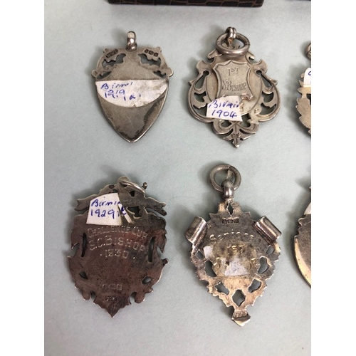 46 - Collection of hallmarked silver watch chain fobs and sporting medals, approximately 79.41g total, an... 