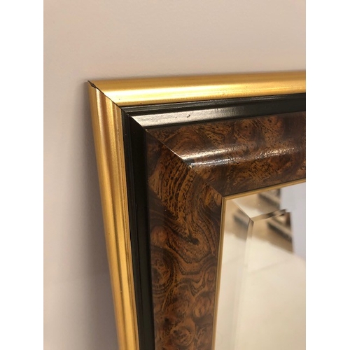 141 - Modern wall mirror of bevelled edged glass in faux walnut frame, approximately 84 x 62 cm