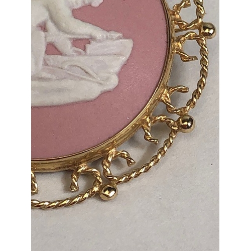 27 - Jasperware pink ground ceramic brooch in a 9ct Gold pierced design mount approx 3.6cm in diameter