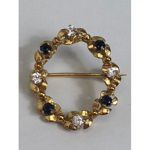 7 - 9ct Gold wreath design oval brooch set with white and blue gemstones approx 2.6cm tall and 1.7g
