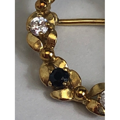 7 - 9ct Gold wreath design oval brooch set with white and blue gemstones approx 2.6cm tall and 1.7g