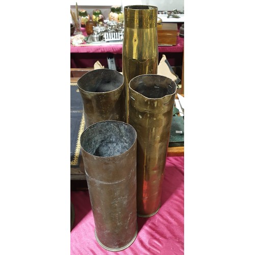 20 - Four brass shell casings, the tallest 17