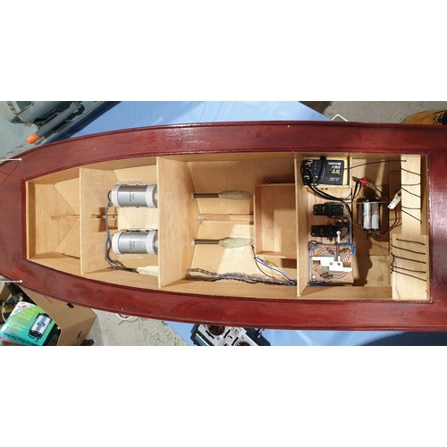 4 - A remote control boat with a controller, length 49