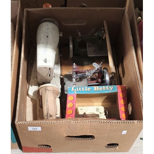 157 - A box of toy sewing machines.