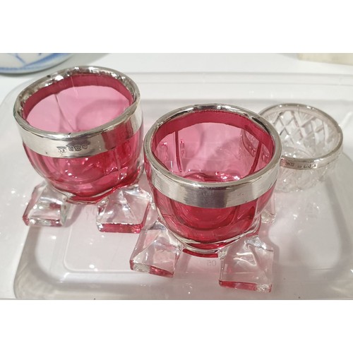 236 - A pair of cranberry glass salts with hallmarked silver rims and one other silver rimmed glass salt.