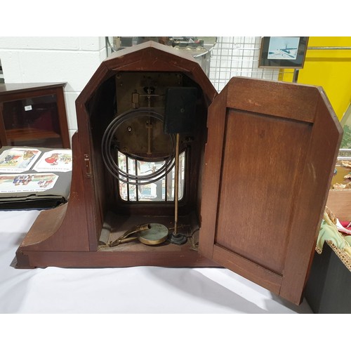 31 - An early 20th century oak cased mantel clock. No in-house shipping. Please arrange collection or you... 