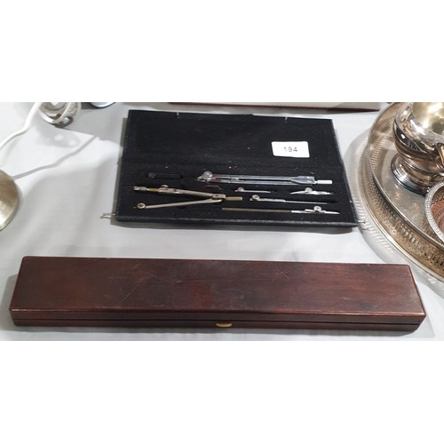 194 - A compass set and slide rule in a mahogany case.

UK shipping £14.