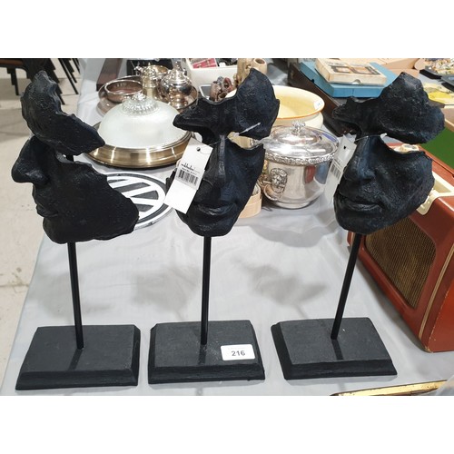 216 - Three resin masks on stands, height 14