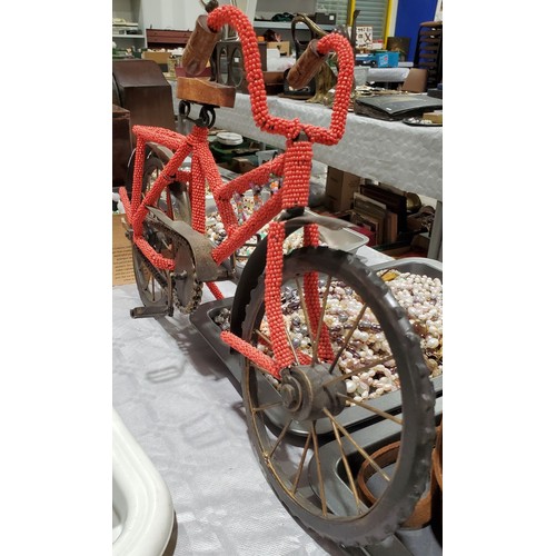 43 - A model bike covered in beads, length 19