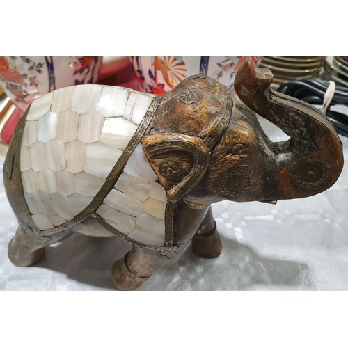 46 - A wooden model of an elephant with applied brass and mother of pearl decoration, height 6.5