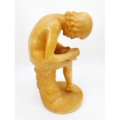 158 - An alabaster figure of a youth attending to his foot, height 9.5