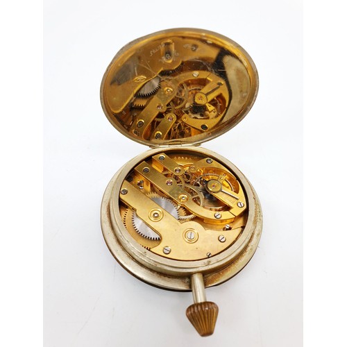 165 - A vintage travelling clock movement mounted in a later wooden stand having enamel dial, diameter 2.5... 