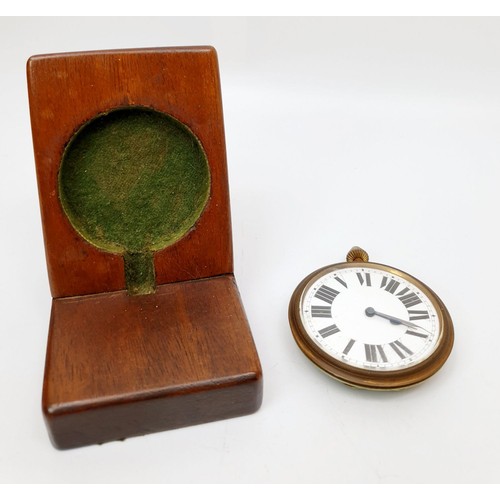 165 - A vintage travelling clock movement mounted in a later wooden stand having enamel dial, diameter 2.5... 