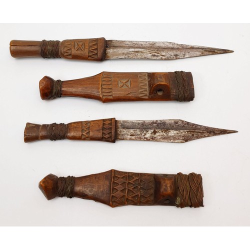 183 - Two antique carved wooden daggers, the longest 8