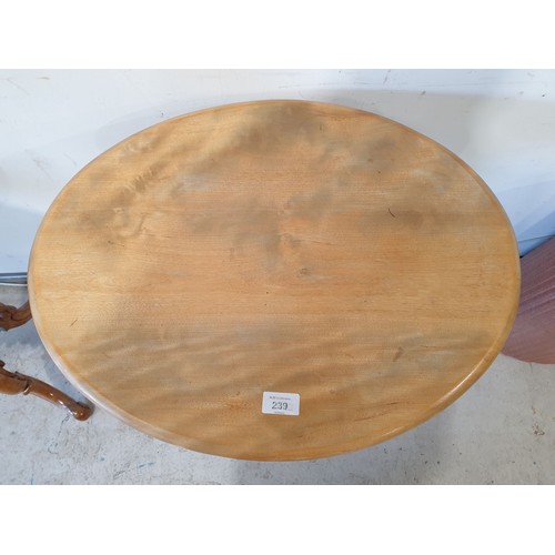 239 - An antique tripod table with an oval top, height 28.5