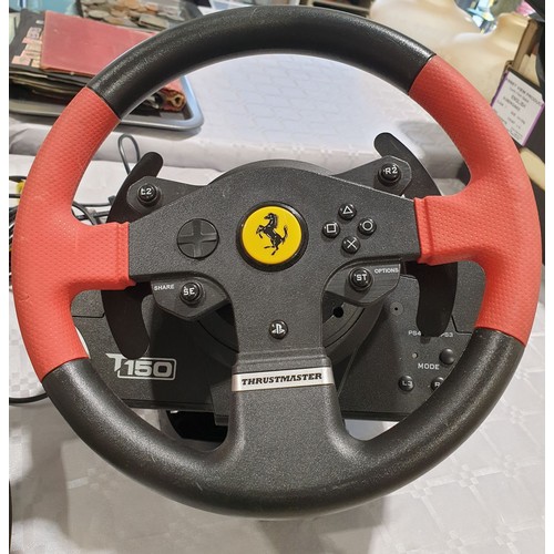 299 - A Thrust Master Playstation T150 Ferrari steering wheel and pedals. UK shipping £14.