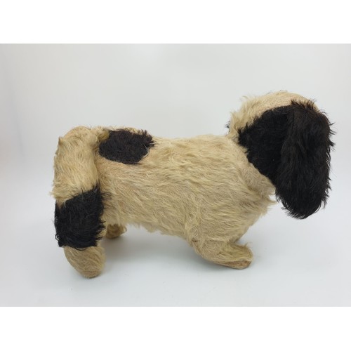 312 - A vintage straw filled dog soft toy, length 10.75