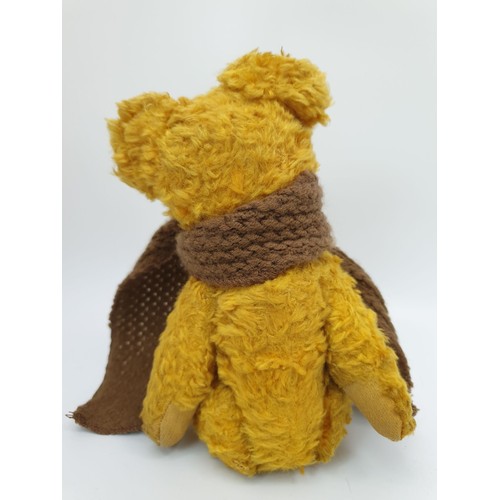 314 - A vintage straw filled articulated teddy bear, length 9.25