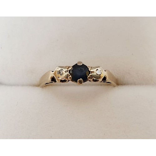 289 - An 18ct gold ring set with diamonds and a blue stone, weight 1.7g, size G/H. UK shipping £14.