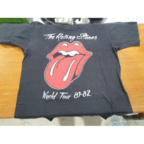 73 - A vintage The Rolling Stones tee-shirt together with a ticket  for the  Rolling Stone's 