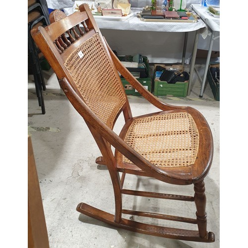 134 - An early 20th century oak and cane work rocking chair together with one other chair. No shipping. Ar... 