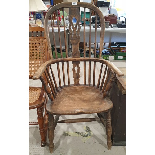 133 - An antique yew Windsor arm chair. No shipping. Arrange collection or your own packer and shipper, pl... 