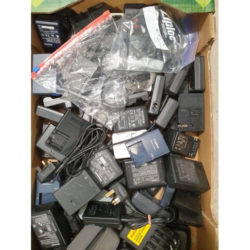 149 - A box of camera battery chargers. UK shipping £14.