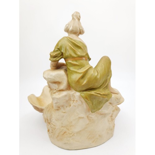 209 - A Royal Dux figure of a lady drawing water beside a shell pool, A/F, height 9.5