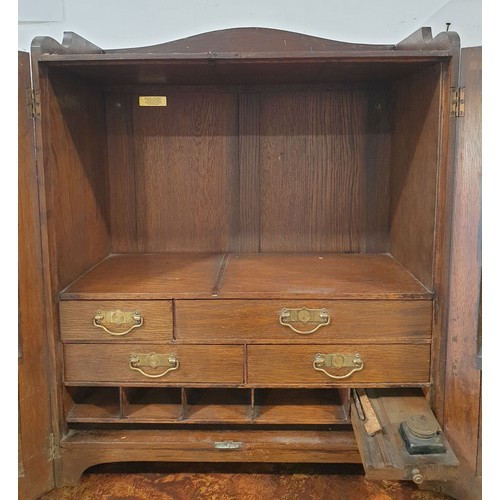 268 - An early 20th century cabinet with four internal drawers and pigeonholes, and an ink stand, height 2... 