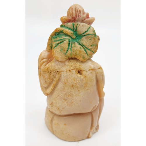 288 - A Chinese soap stone figure of a monk holding a garland above his head, length 3