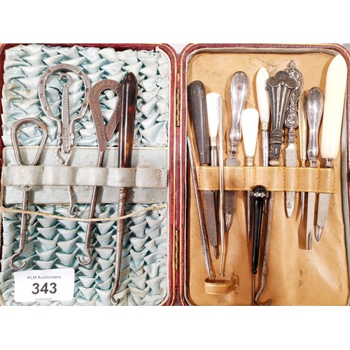 343 - Manicure items and button hooks, two with silver handles. UK shipping £14.