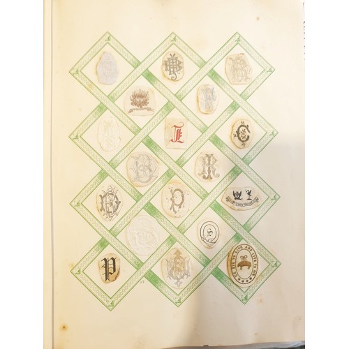 429 - An antique Crests and Monogram album with twenty one fully populated pages and three partially popul... 