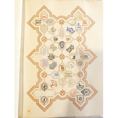 429 - An antique Crests and Monogram album with twenty one fully populated pages and three partially popul... 