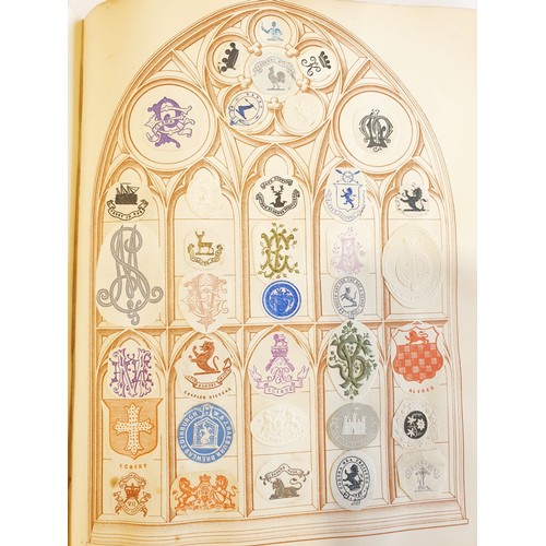 429 - An antique Crests and Monogram album with twenty one fully populated pages and three partially popul... 