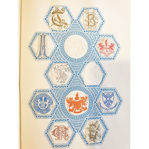 429 - An antique Crests and Monogram album with twenty one fully populated pages and three partially popul... 