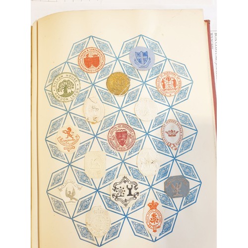 429 - An antique Crests and Monogram album with twenty one fully populated pages and three partially popul... 