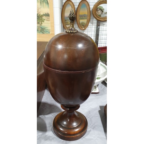 13 - A wooden lidded urn with a brass finial, height 14.5