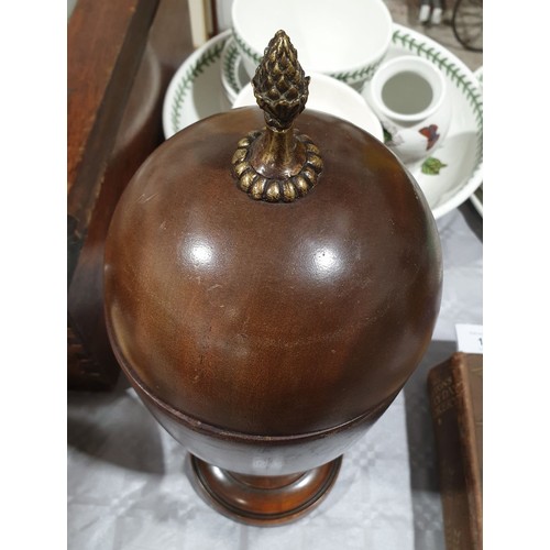 13 - A wooden lidded urn with a brass finial, height 14.5